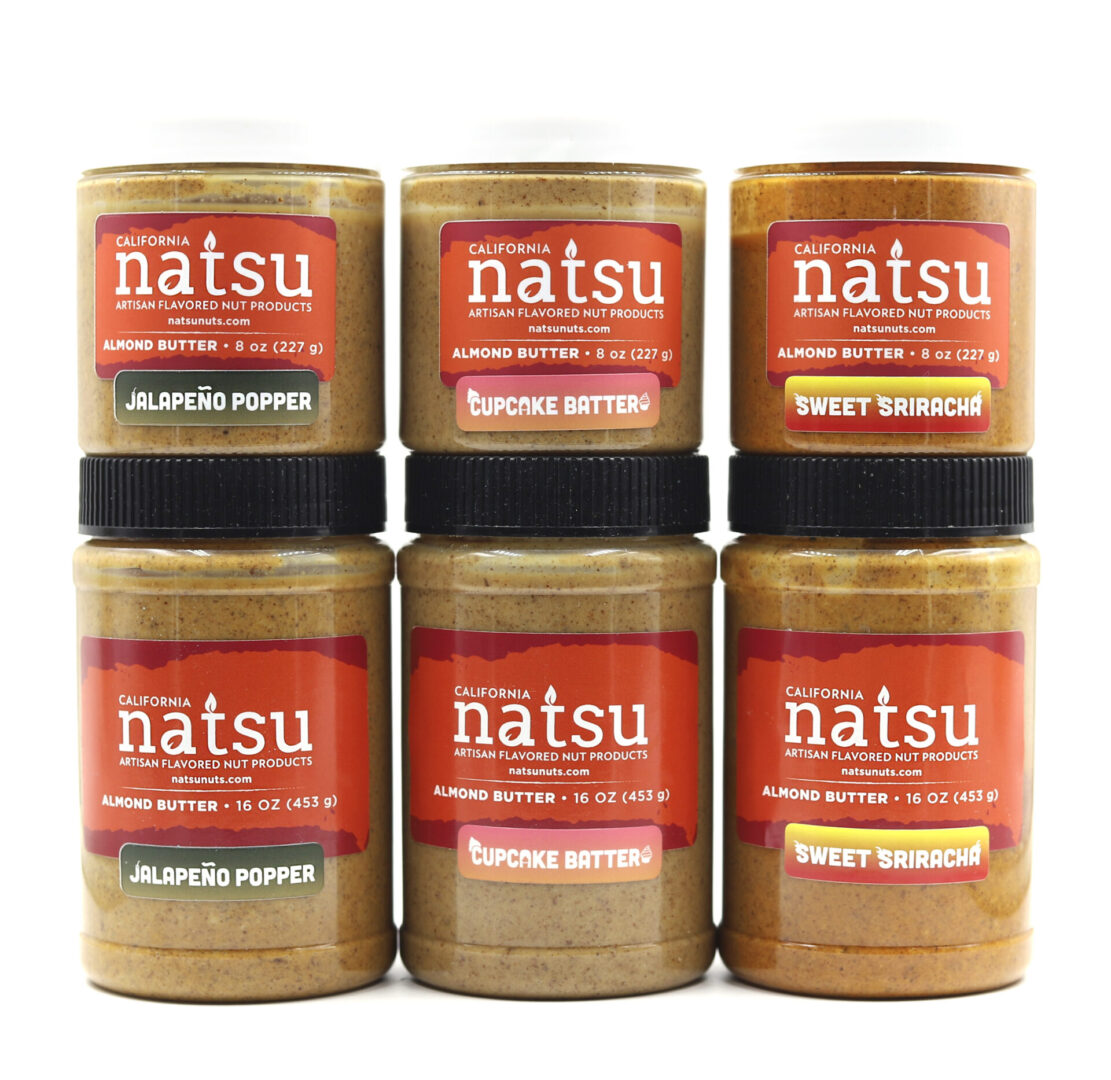 Natsu 1 A group of six jars of peanut butter.