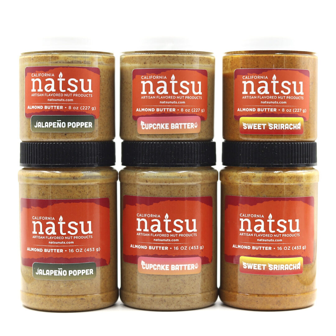 A group of six jars of peanut butter.
