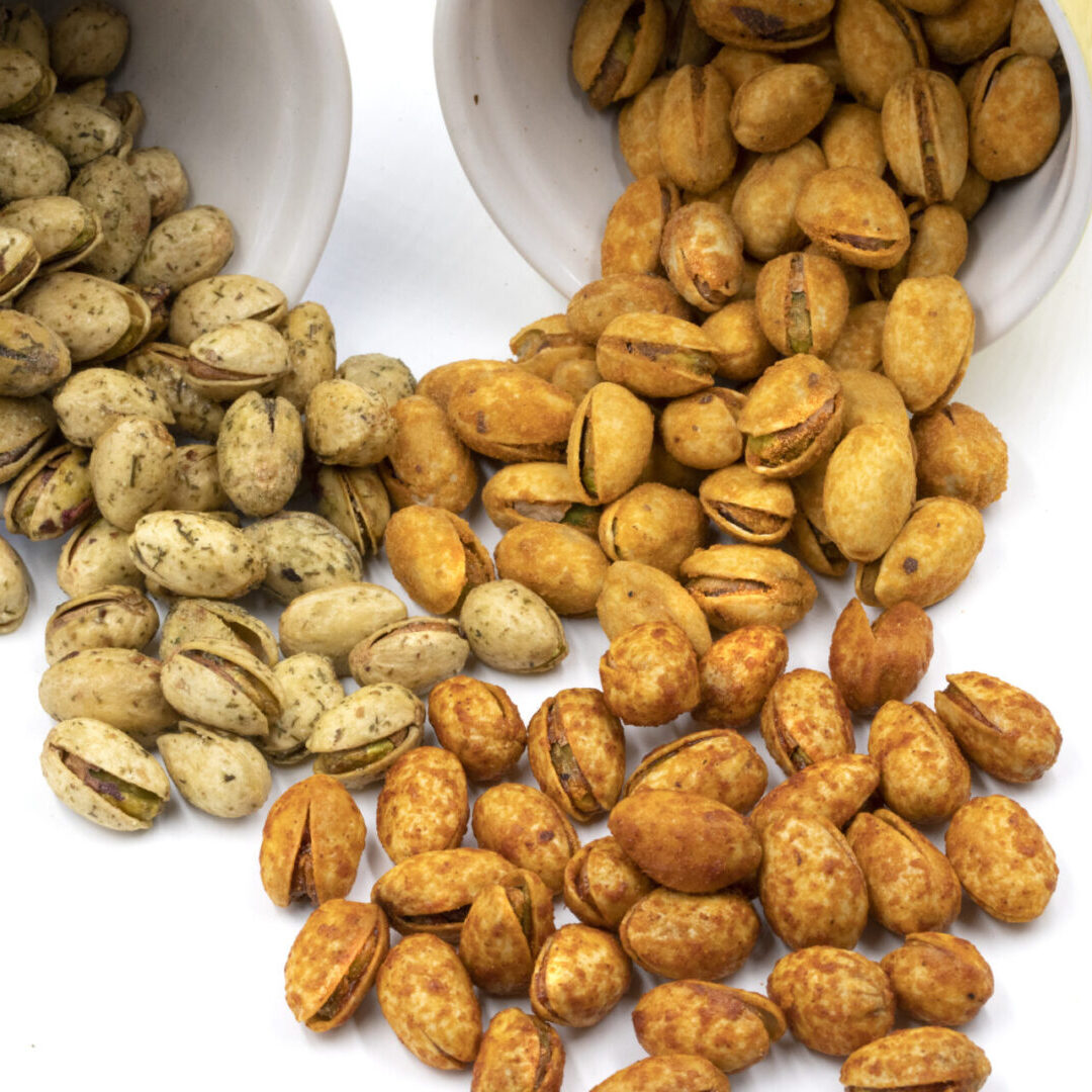 A close up of three bowls with nuts