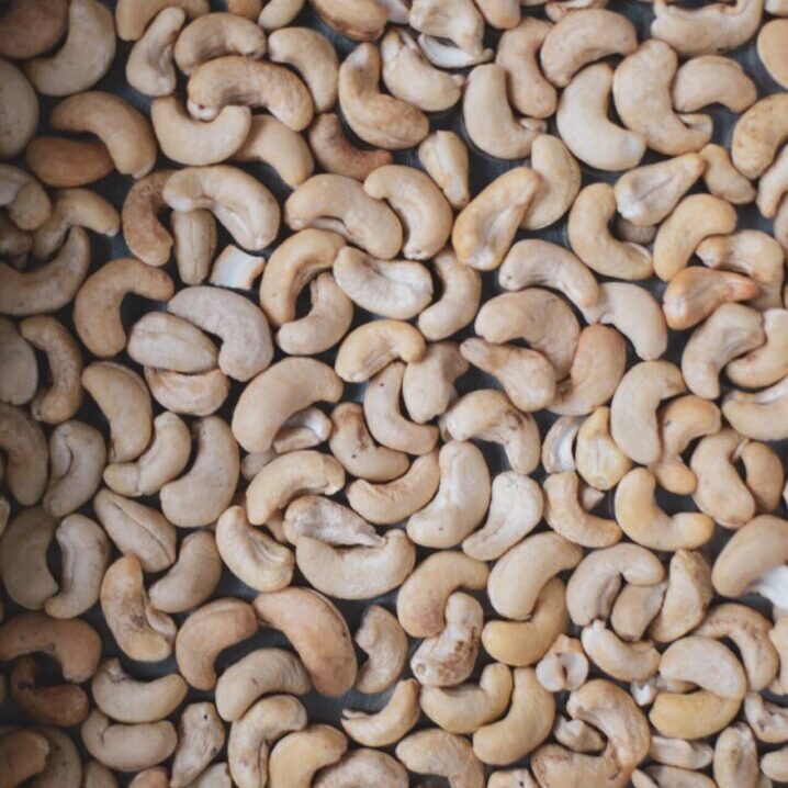 A close up of cashews in the middle of a pile