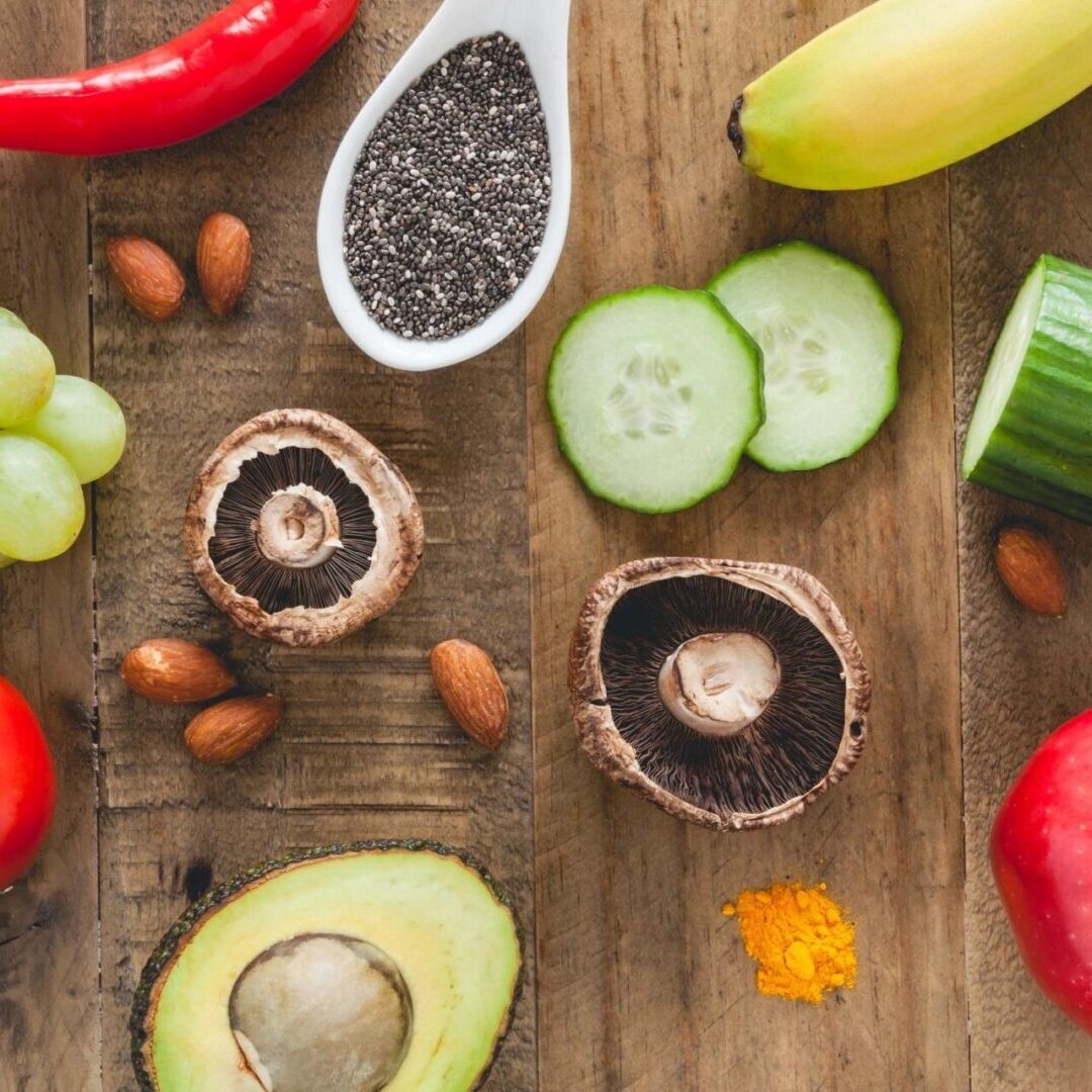 A wooden table topped with lots of different fruits and vegetables.