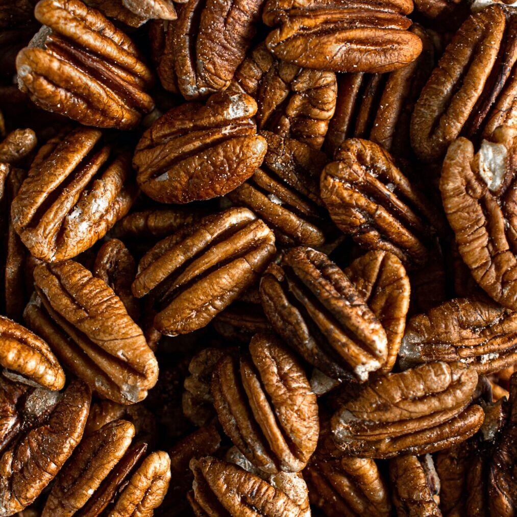 A close up of pecans in the shell